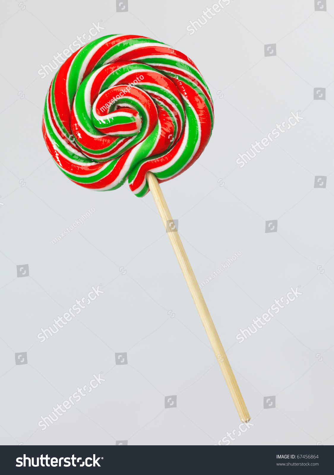 Red And Green Colored Lollipop On A Stick Isolated On Gray Background ...