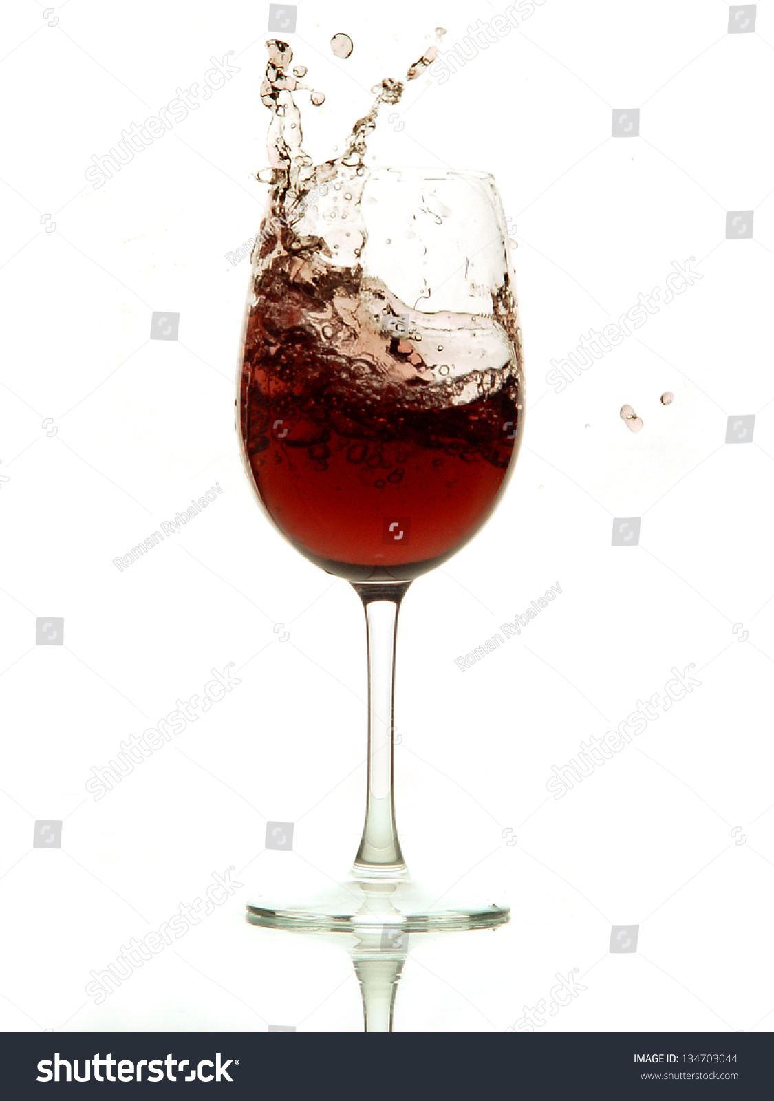 Red Wine Splashing Out Of A Glass Isolated On White Stock Photo