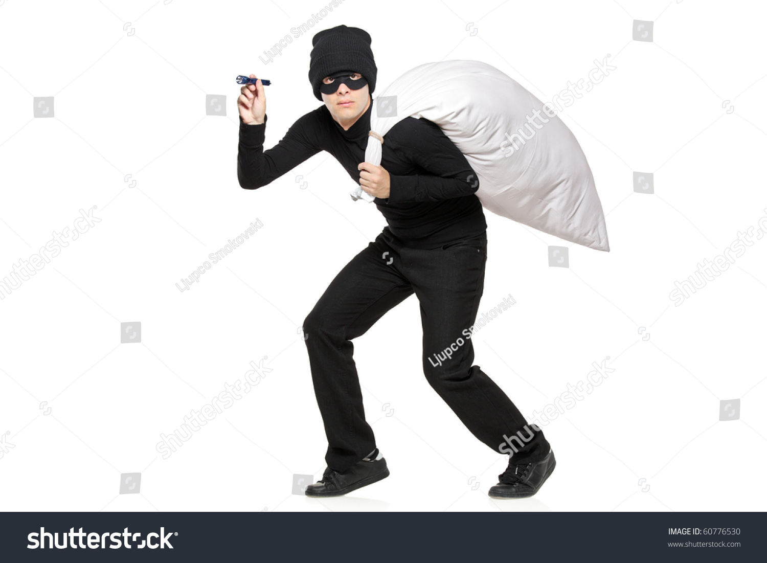 stock-photo-robber-with-a-bag-and-flashl