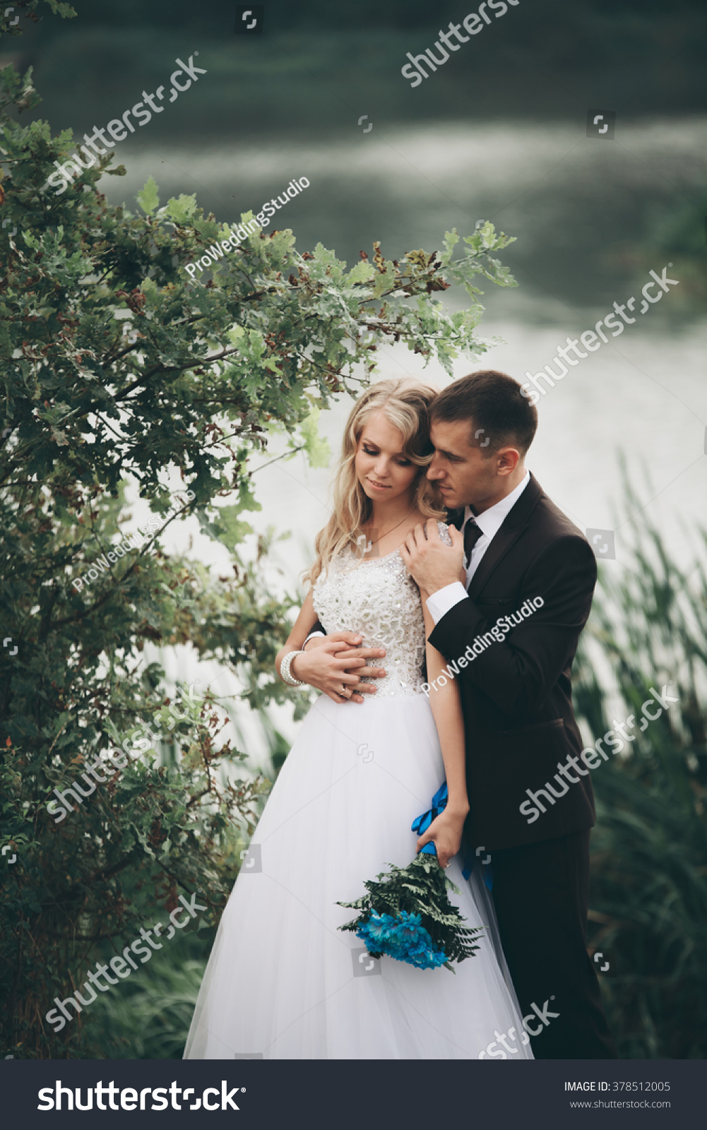 Romantic wedding couple man and wife posing near beautiful lake Romantic wedding couple man and wife posing near beautiful lake