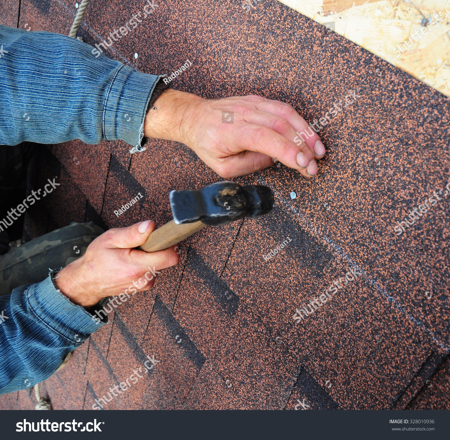 Roofer Install Bitumen Roof Asphalt Shingles With Hammer - Closeup On ...