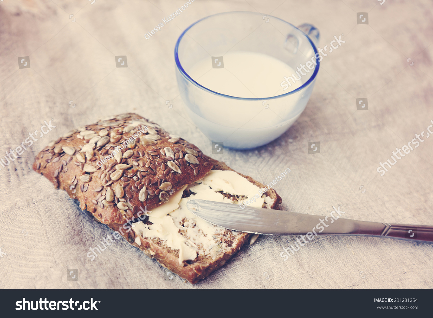 rye grain bread with butter and a cup of milk close-up rye grain bread with butter and a cup of milk close-up