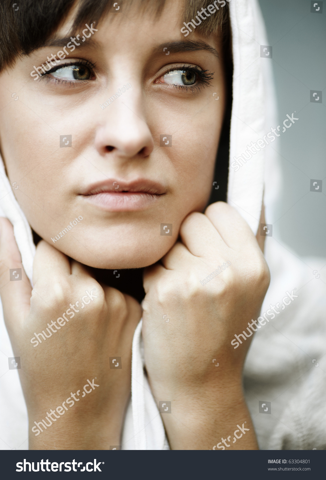 sadness-in-her-eyes-close-up-of-young-woman-with-white-hood-natural