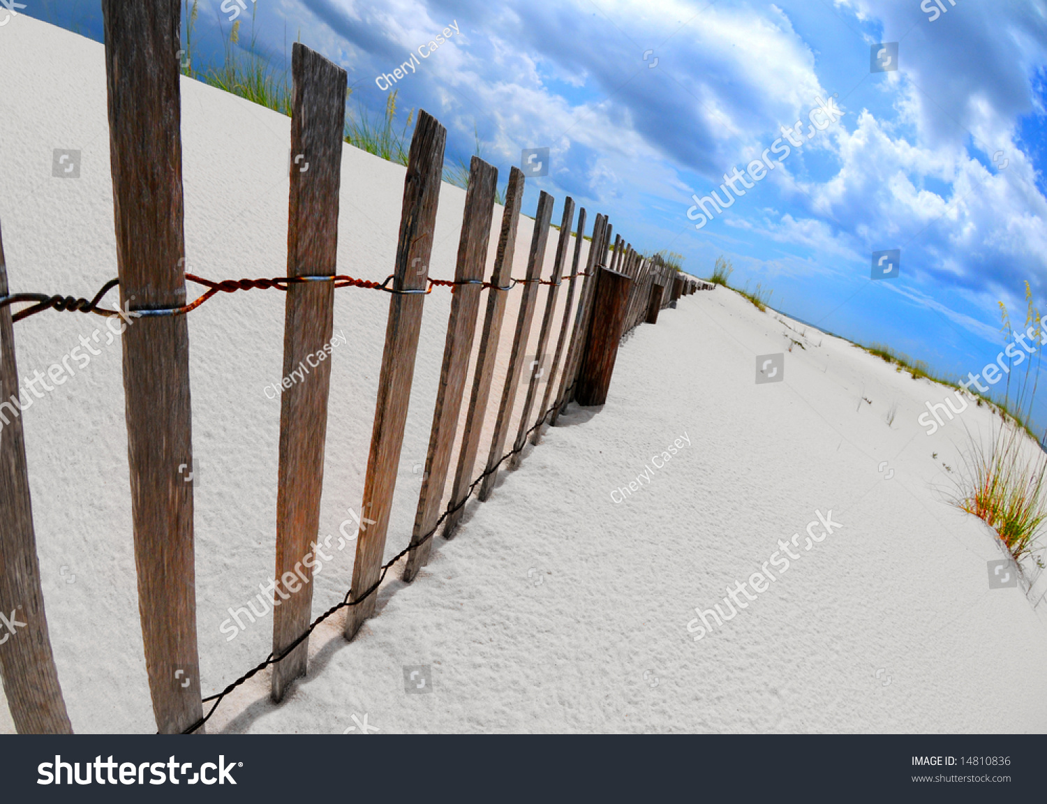 Sand Dune Fence Stretching Over Beautiful Coastal Area Stock Photo