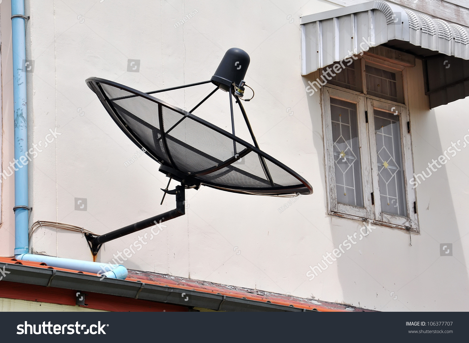 Satellite Dish Is Attached To The Wall Of The House Stock ...