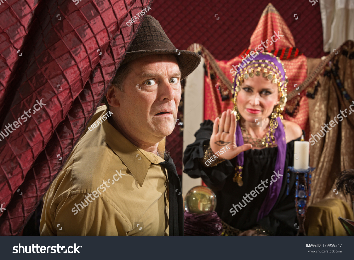 Scared Businessman And Fortune Teller Displaying The Evil Eye Stock