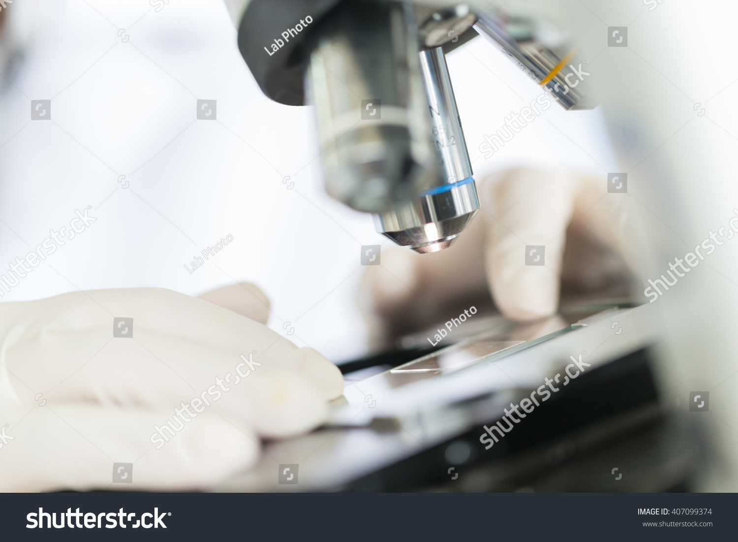 Scientist hands with microscope examining samples Scientist hands with microscope examining samples
