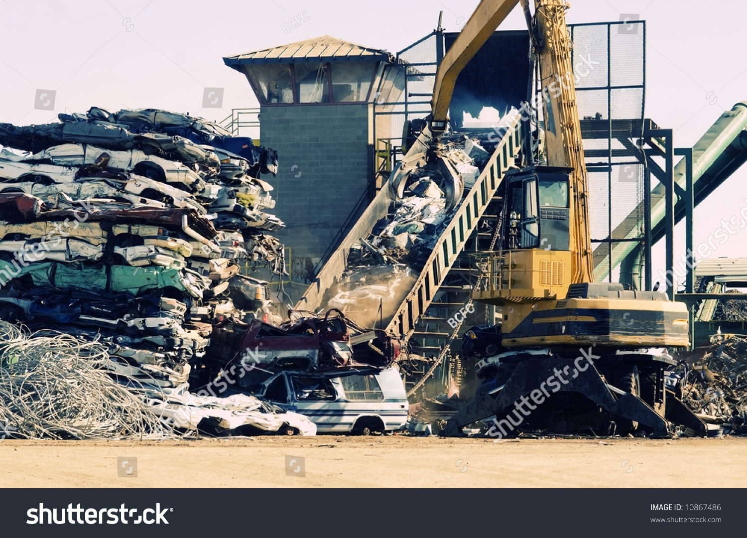 Scrap Metal Junk Yard, Giant Crane Picking Up Pieces Of Old Cars For