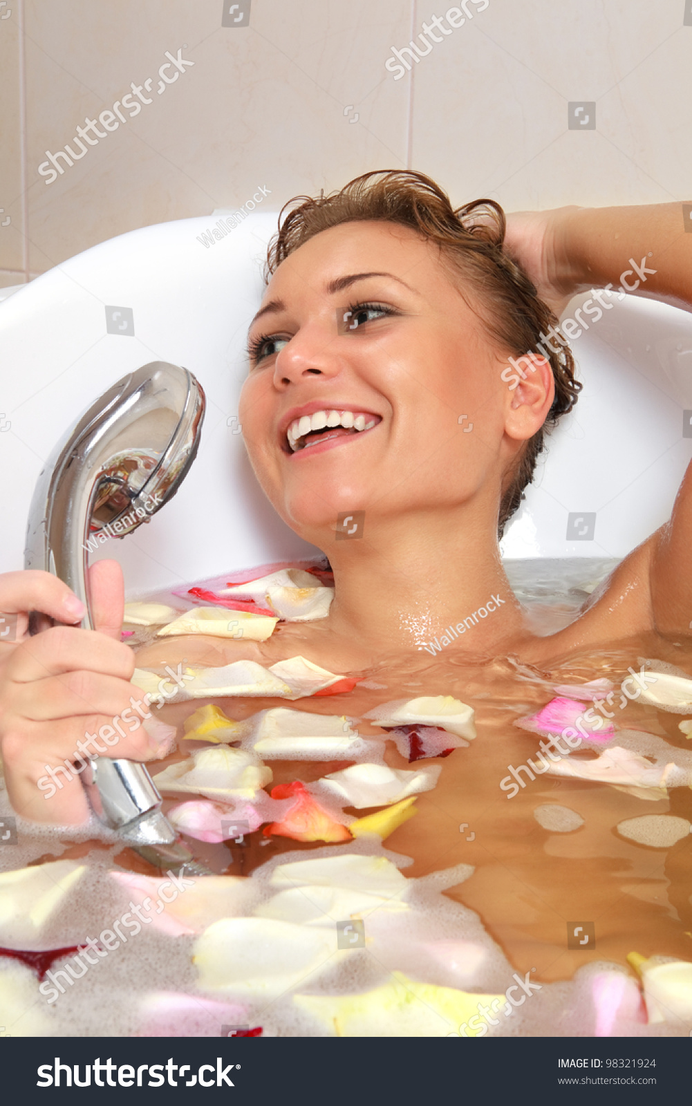 Sensual Woman Relaxing In Bathtub With Foam Soap Sud And Rose Petal