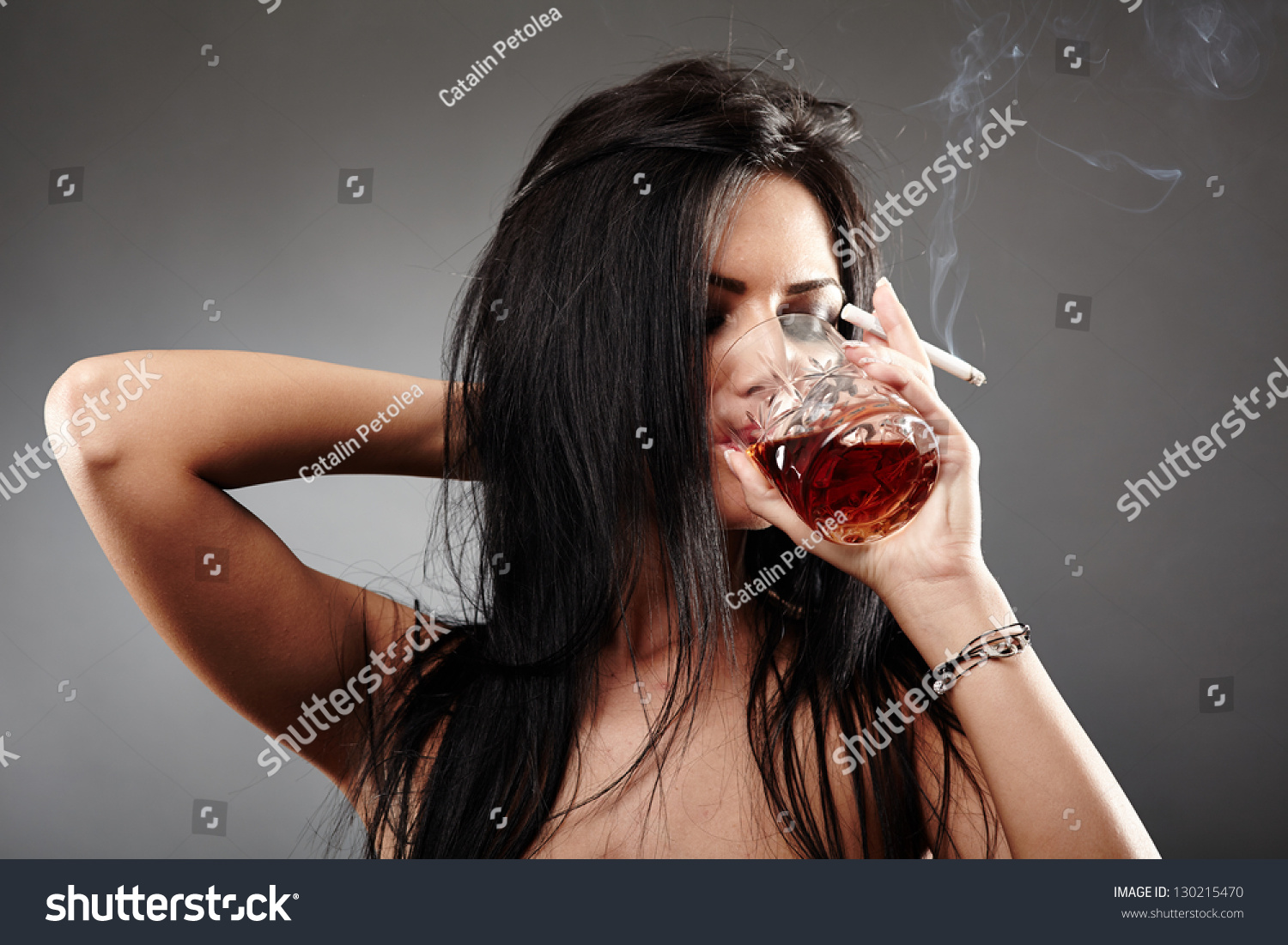 Sensual Young Woman Drinking A Glass Of Brandy And Smoking A Cigarette Closeup Pose Over Gray 8818