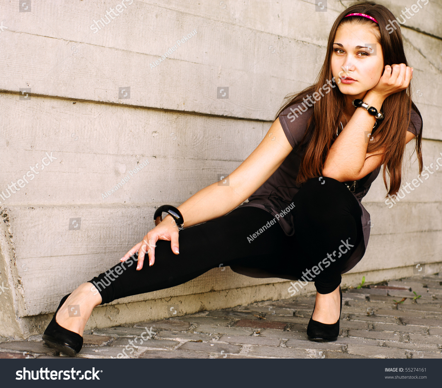 Sepia Portrait Of The Girl Full Body Squatting By The