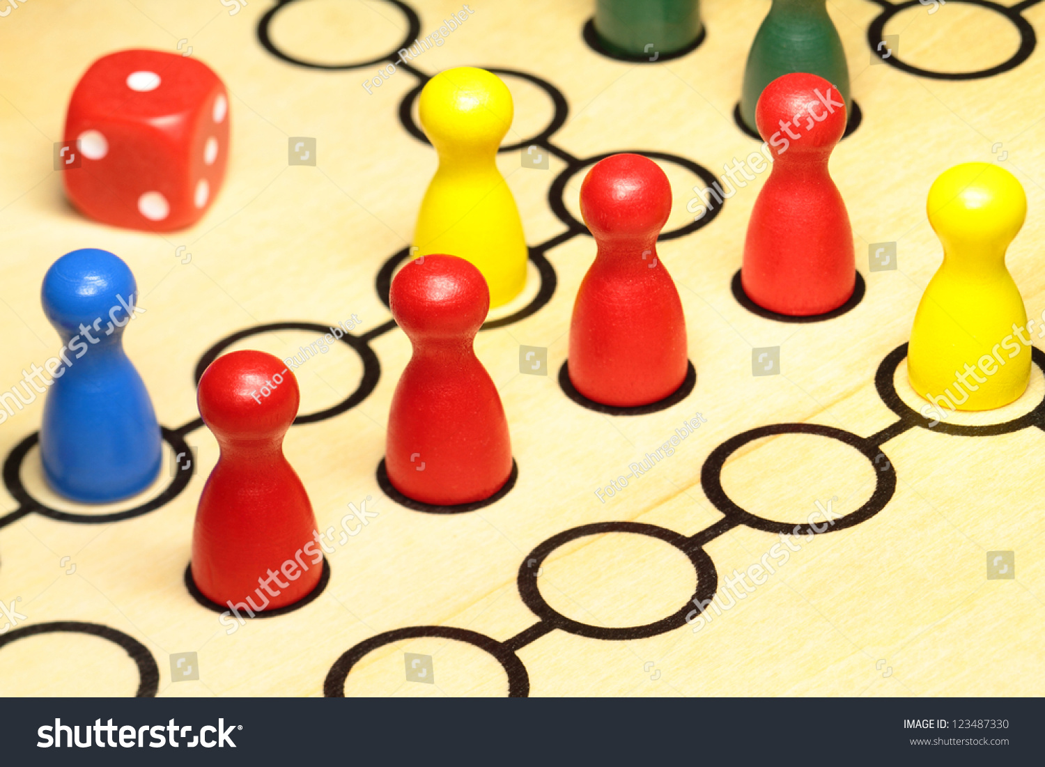 Several play figures are on a board of wood Several play figures are on a board of wood