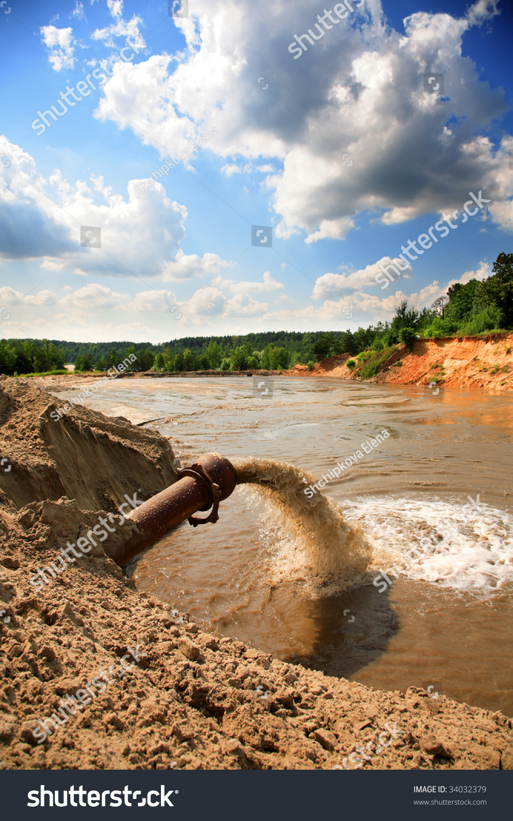 Pipe In River Sewage Flowing From A Pipe In The River Stock Photo