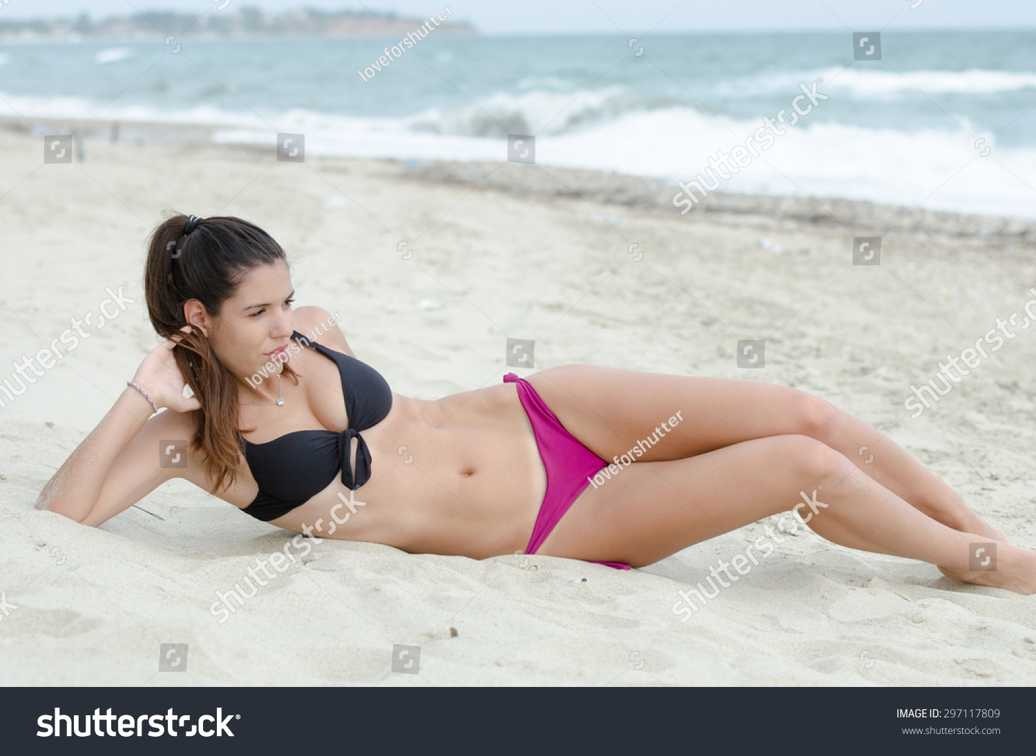 Sexy Athletic Women In Bikini Lying Down On Sand Ocean As Background Stock Photo