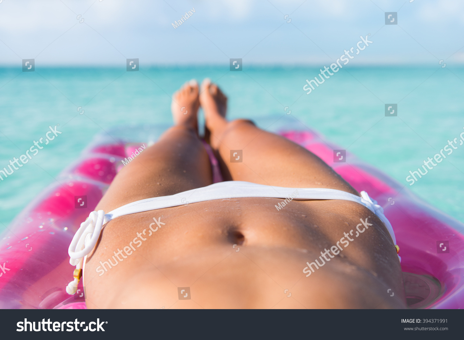 Sexy Bikini Body Abs Stomach Closeup And Tanned Legs Of Beach Woman Relaxing Tanning On Air