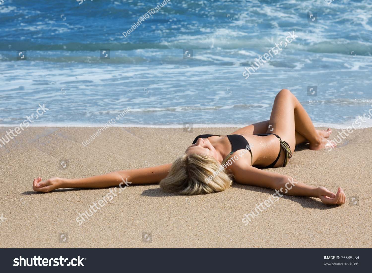 Sexy Girl In Bikini Lying On A Sandy Beach Stock Photo 75545434