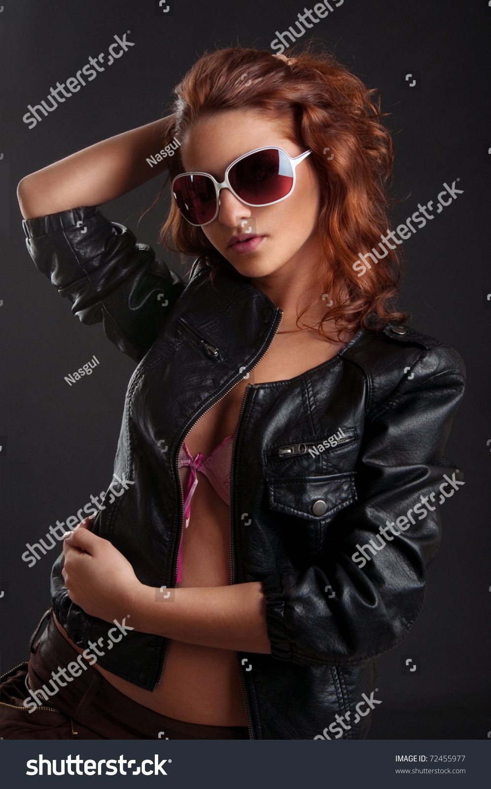 Sexy Redhead Girl In Pink Lingerie And Leather Jacket On The Black