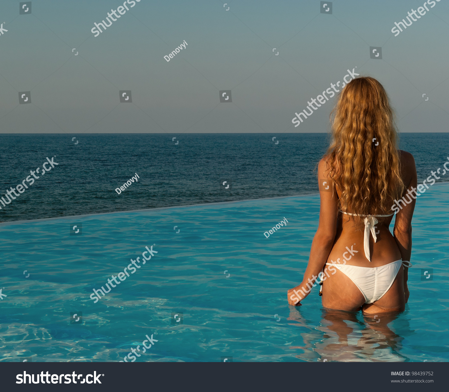 Sexy Woman In White Bikini Relax At Infinity Pool On Sunset Crete