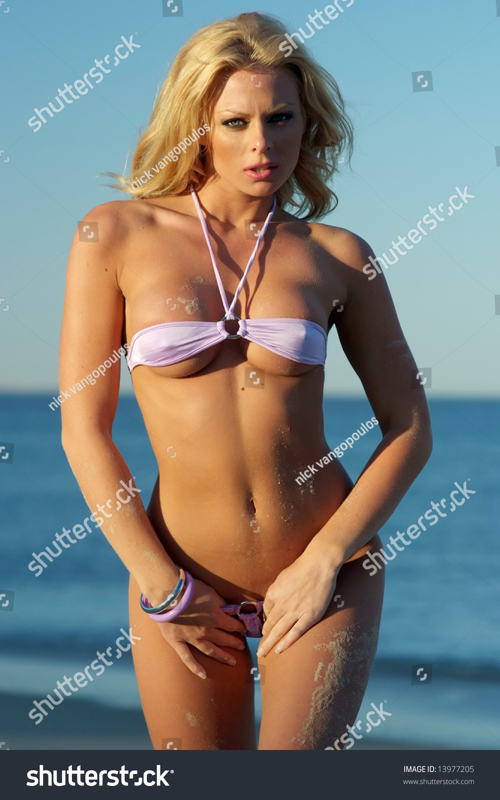 Sexy Woman Wearing Purple Bikini Posing On The Beach Stock Photo Shutterstock