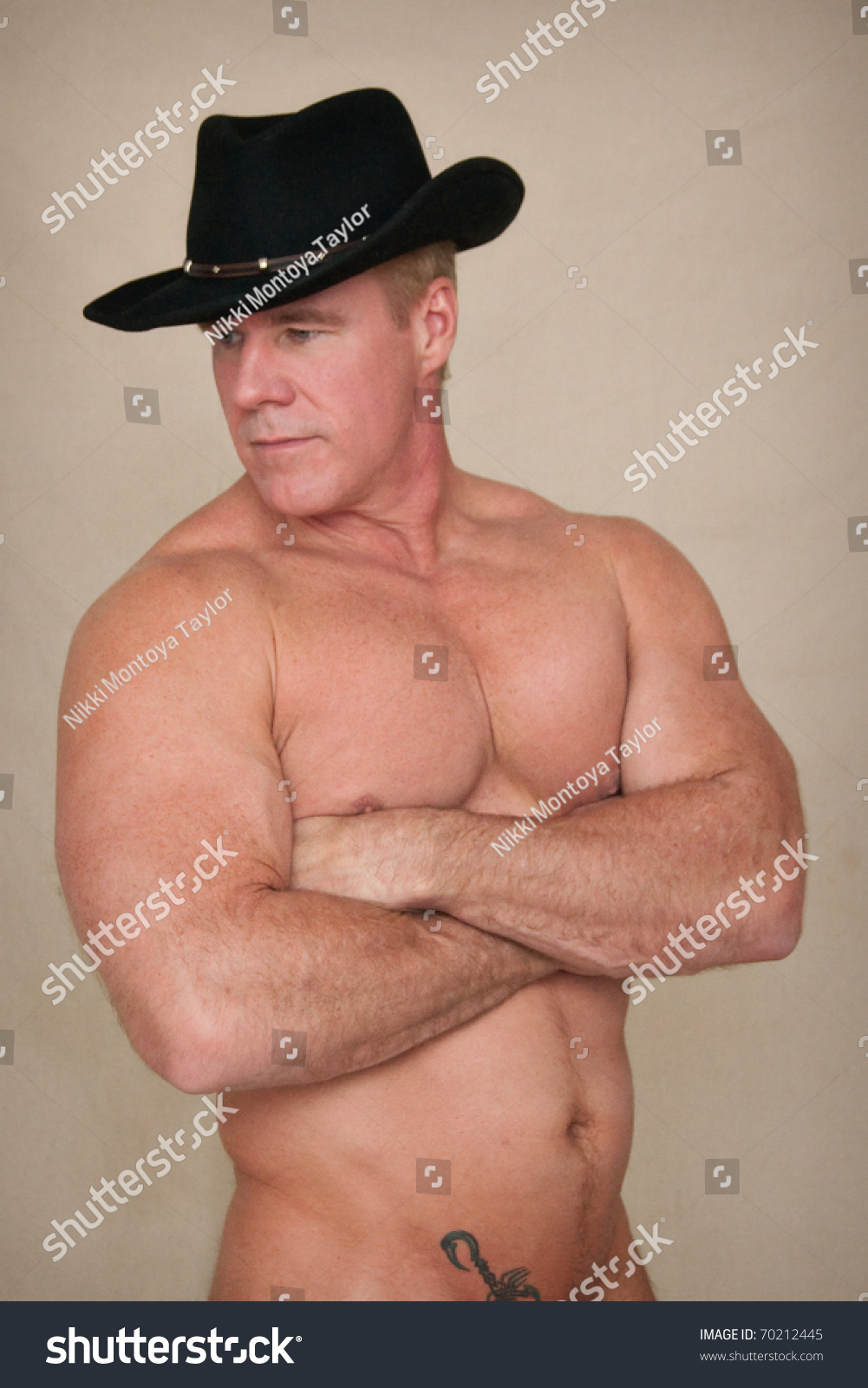 stock-photo-shirtless-cowboy-looks-to-si