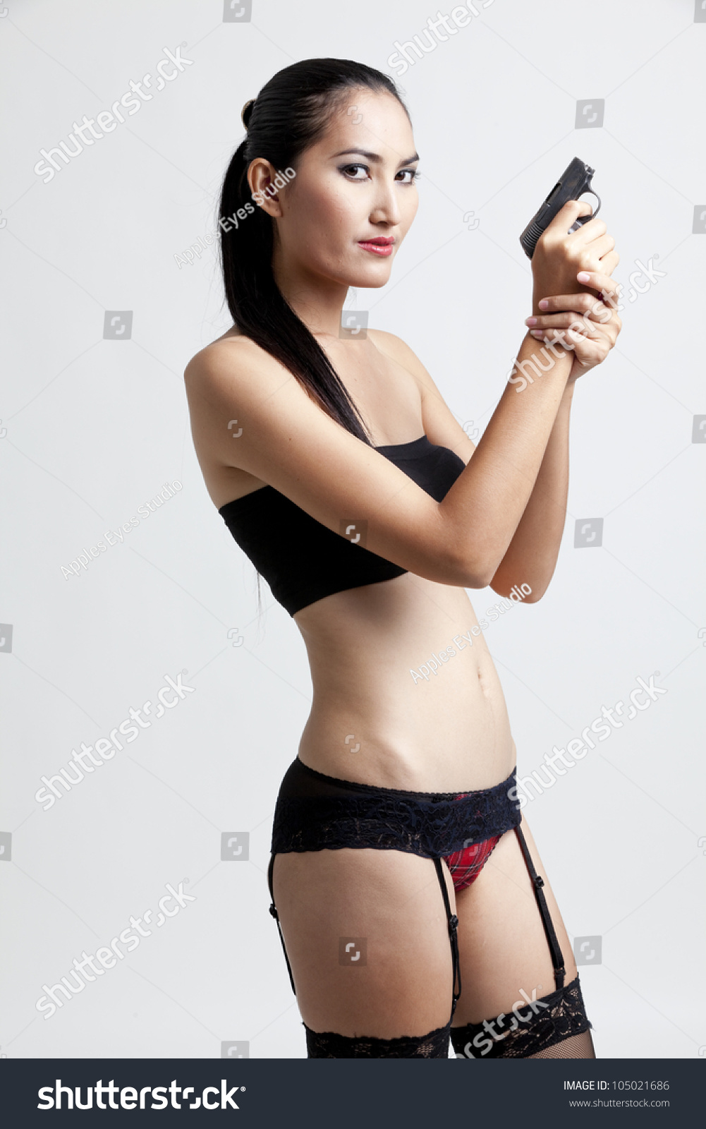 Shot Of A Sexy Woman In Black Hand Holding Gun Stock Photo 105021686