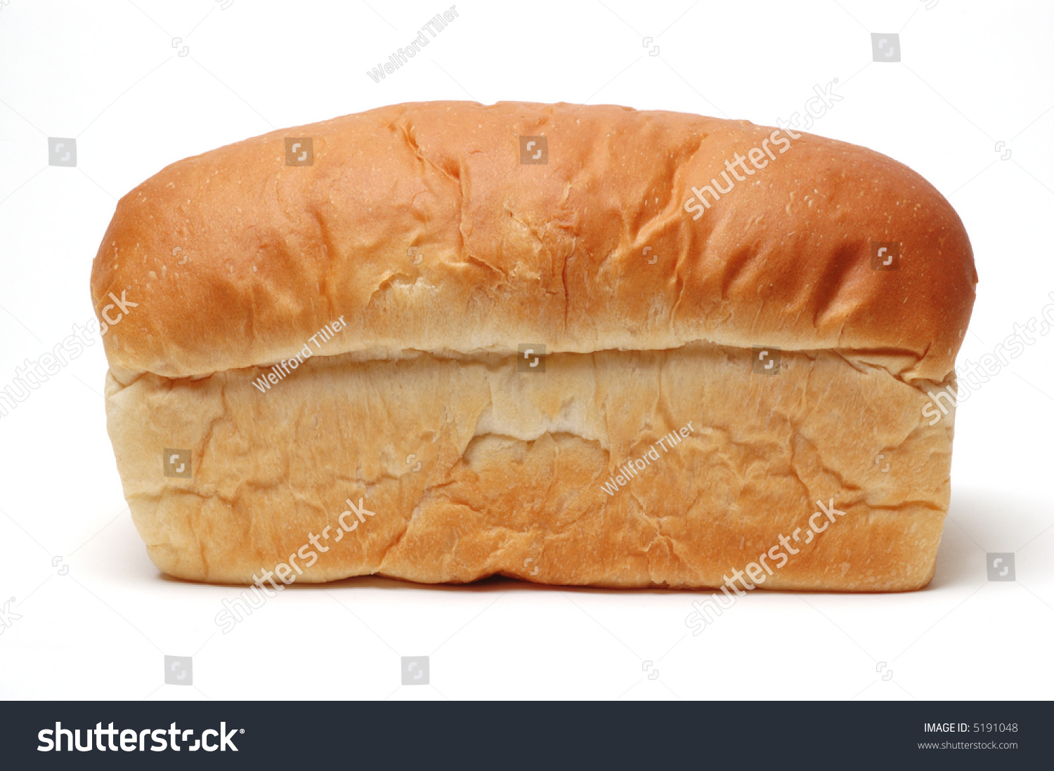 Side View Of A Loaf Of White Bread, Not Sliced, On A White Background