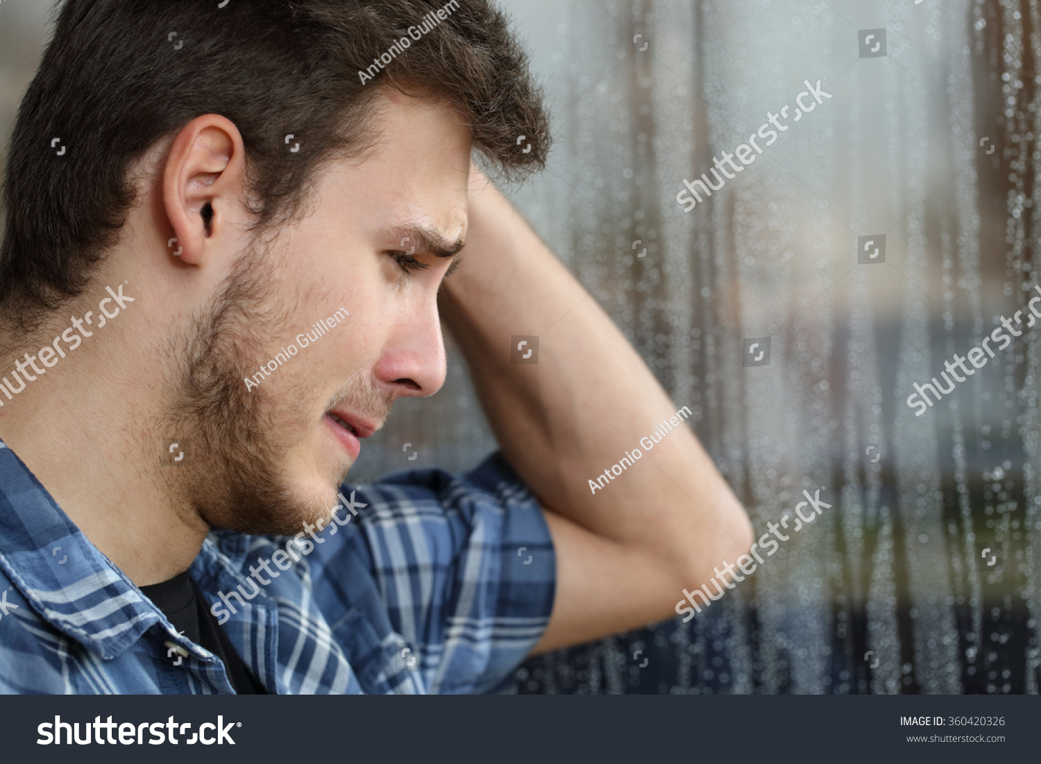 stock-photo-side-view-of-a-sad-man-looki