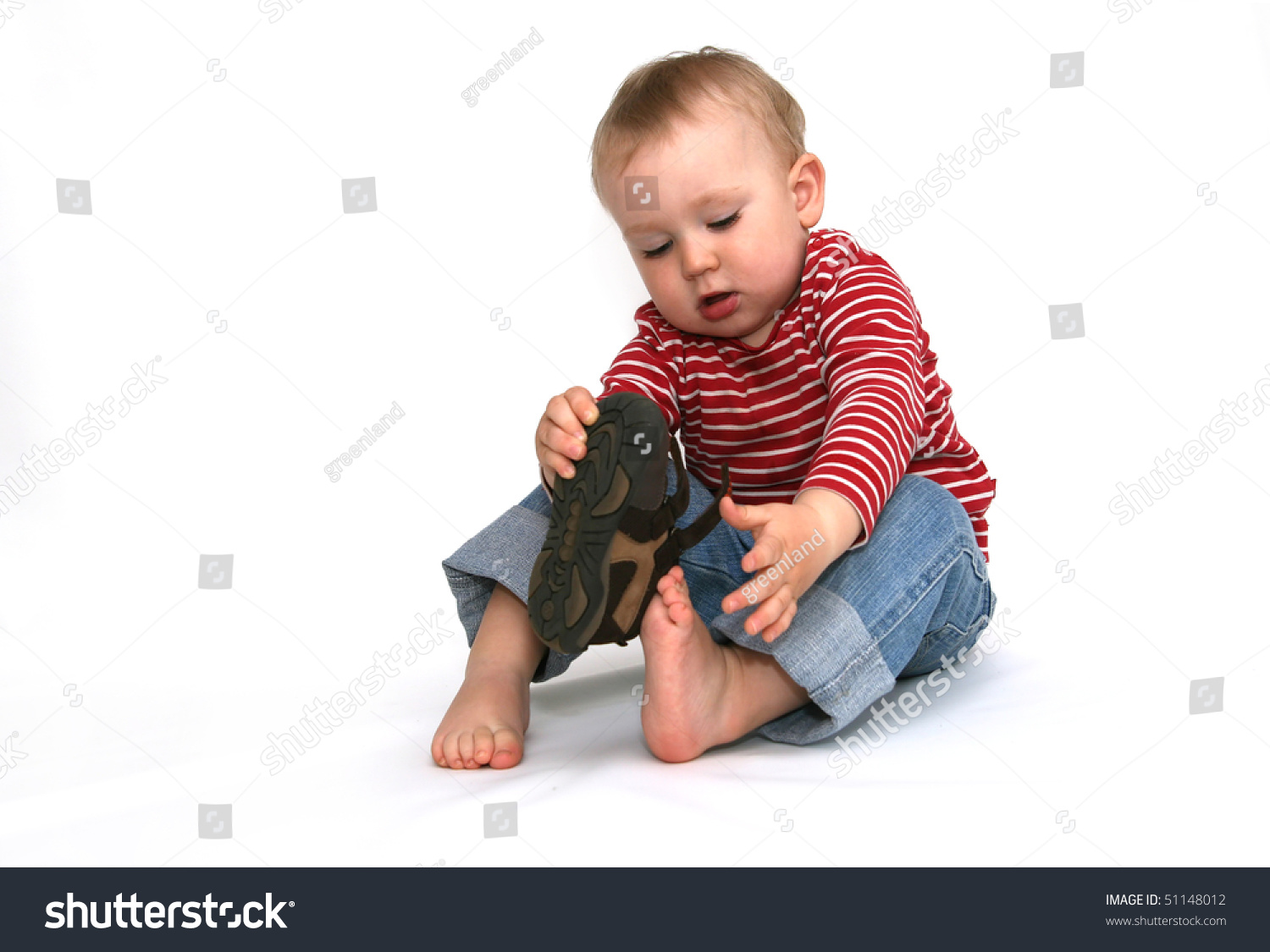 Child putting on his shoes stock image. Image of active 