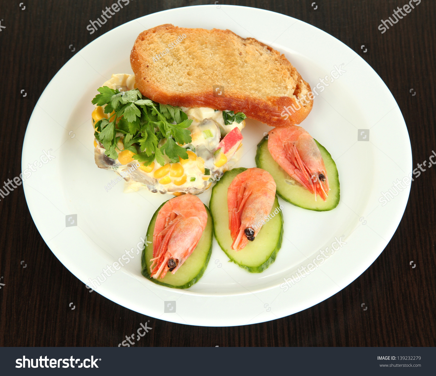 small-portion-of-food-on-big-plate-on-wooden-table-stock-photo