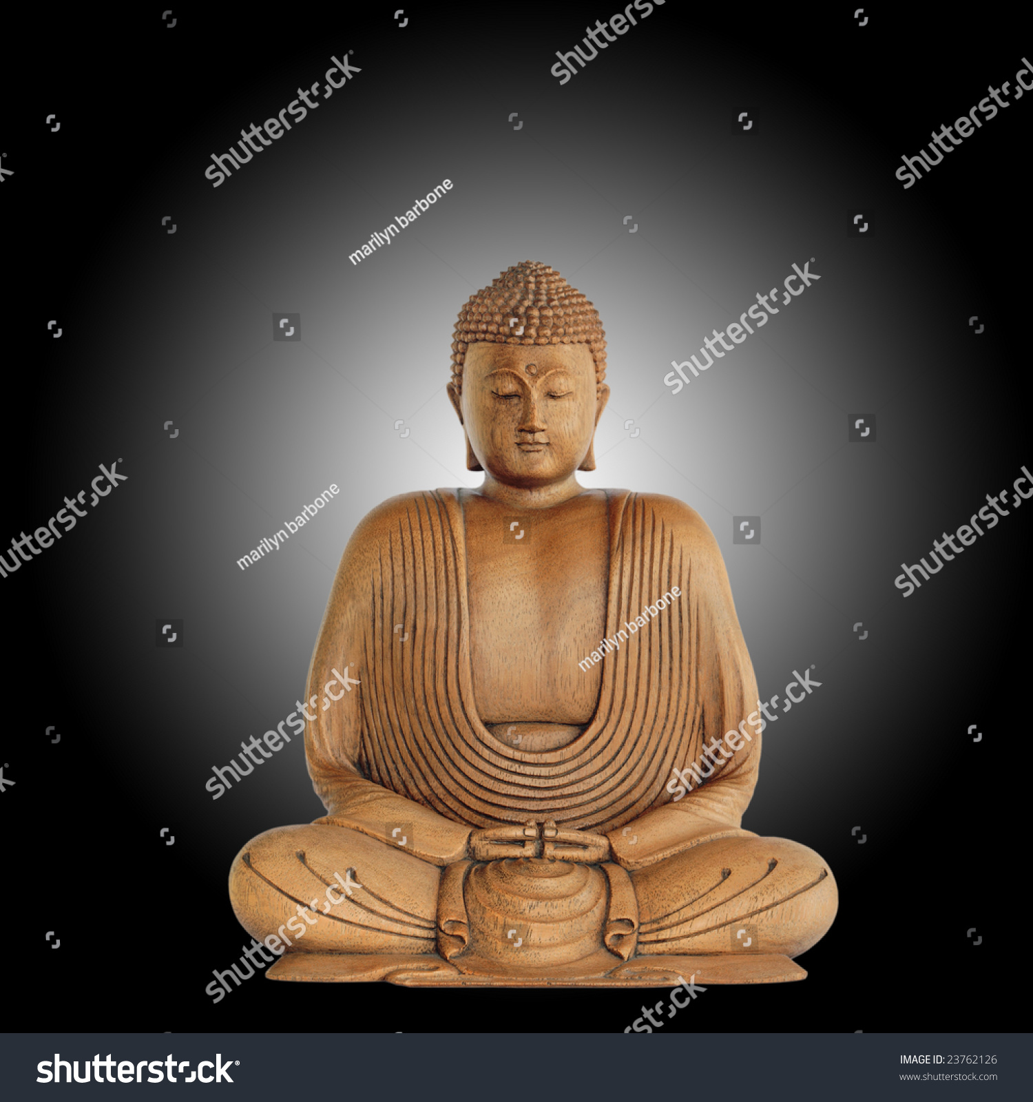 Smiling Buddha With Eyes Closed In Prayer Against A Black Background