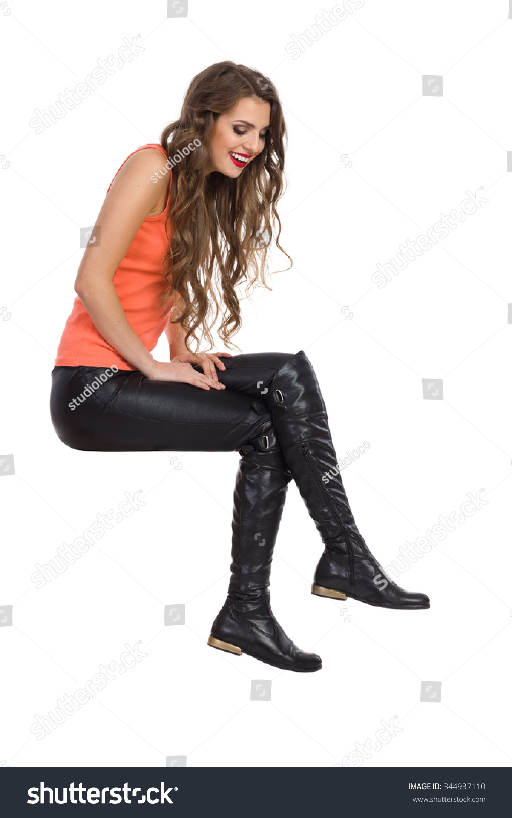 girl sitting leather pants