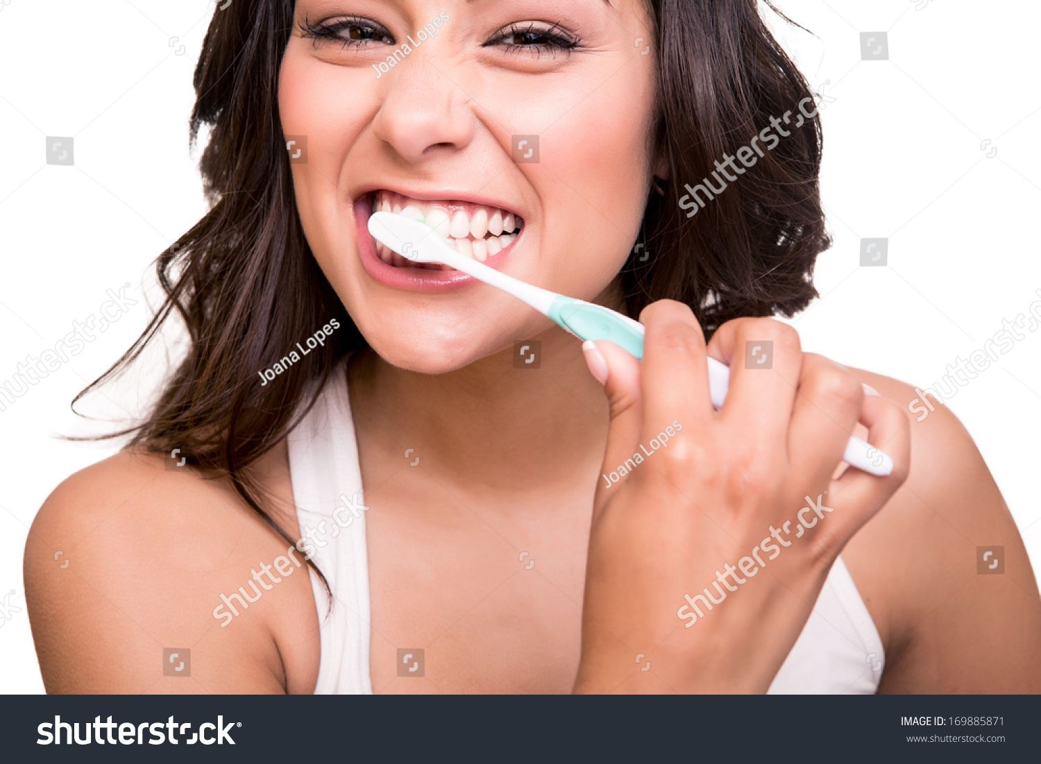 Smiling Young Woman With Healthy Teeth Holding A Tooth