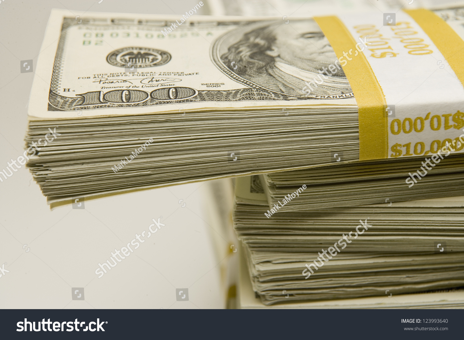 stacks-of-100-bills-banded-in-10-000-amounts-stock-photo-123993640