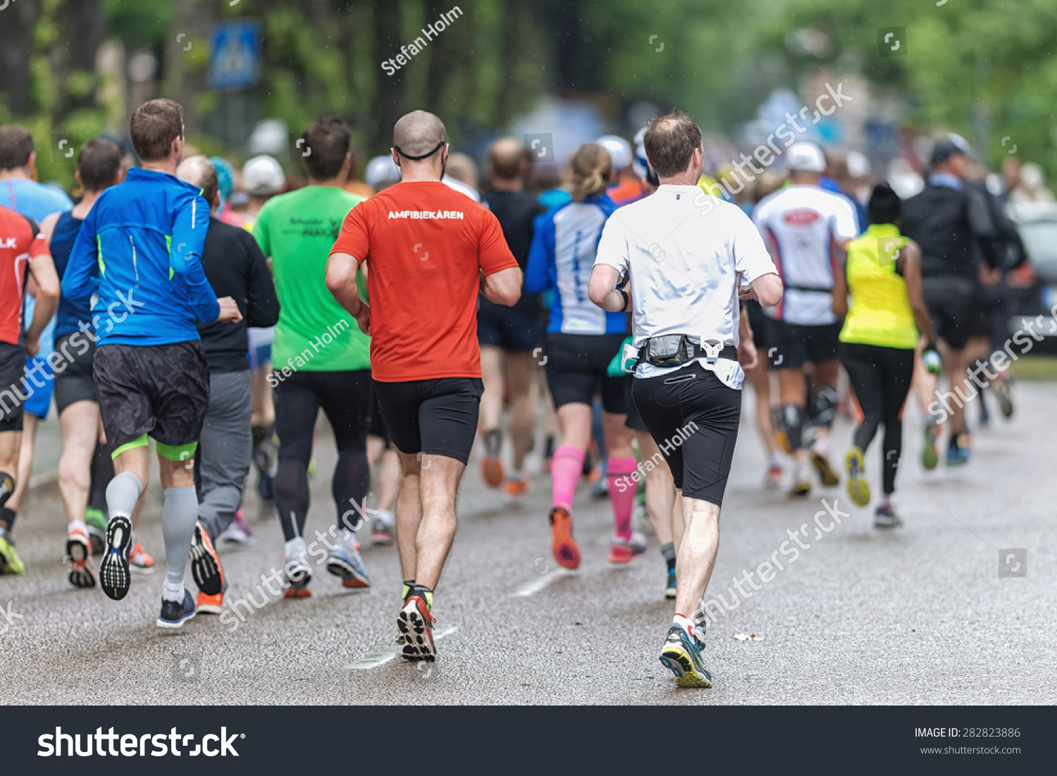 STOCKHOLM MAY 30 Back of a group of people at the streets of Stockholm at ASICS Stockholm Marathon 2015 May 30 2015 in Stockholm Sweden Runners from 101 nations were registered in 2015 STOCKHOLM MAY 30 Back of a group of people at the streets of Stockholm at ASICS Stockholm Marathon 2015 May 30 2015 in Stockholm Sweden Runners from 101 nations were registered in 2015