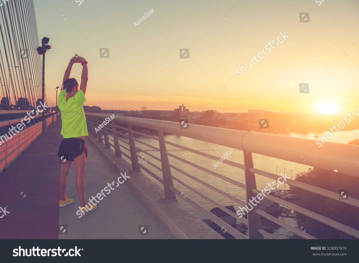 Stretching after jogging on a bridge Stretching after jogging on a bridge