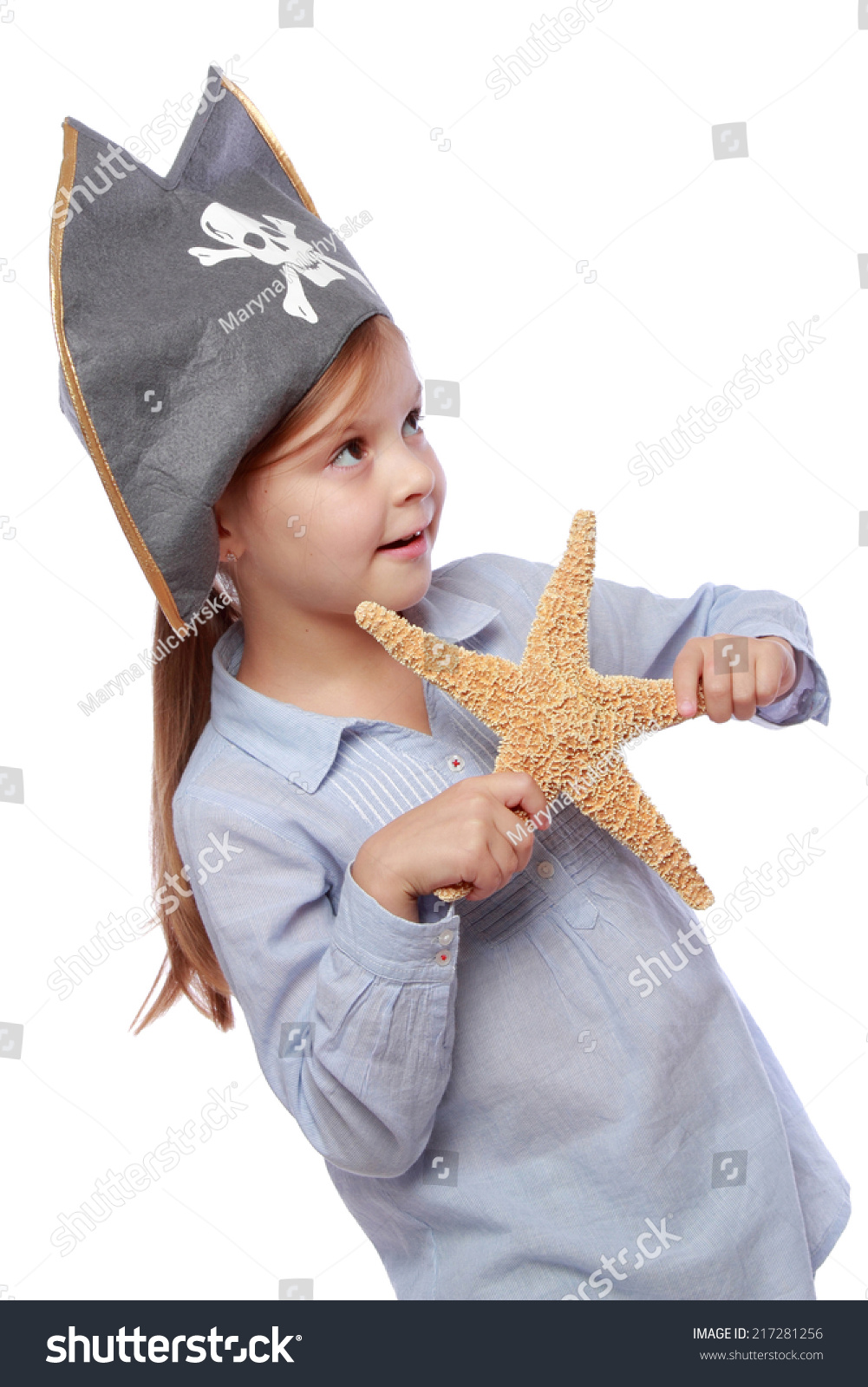 Studio image of a charming emotional little girl with a sweet smile as evil pirate in a pirate hat isolated on white on Holiday Studio image of a charming emotional little girl with a sweet smile as evil pirate in a pirate hat isolated on white on Holiday