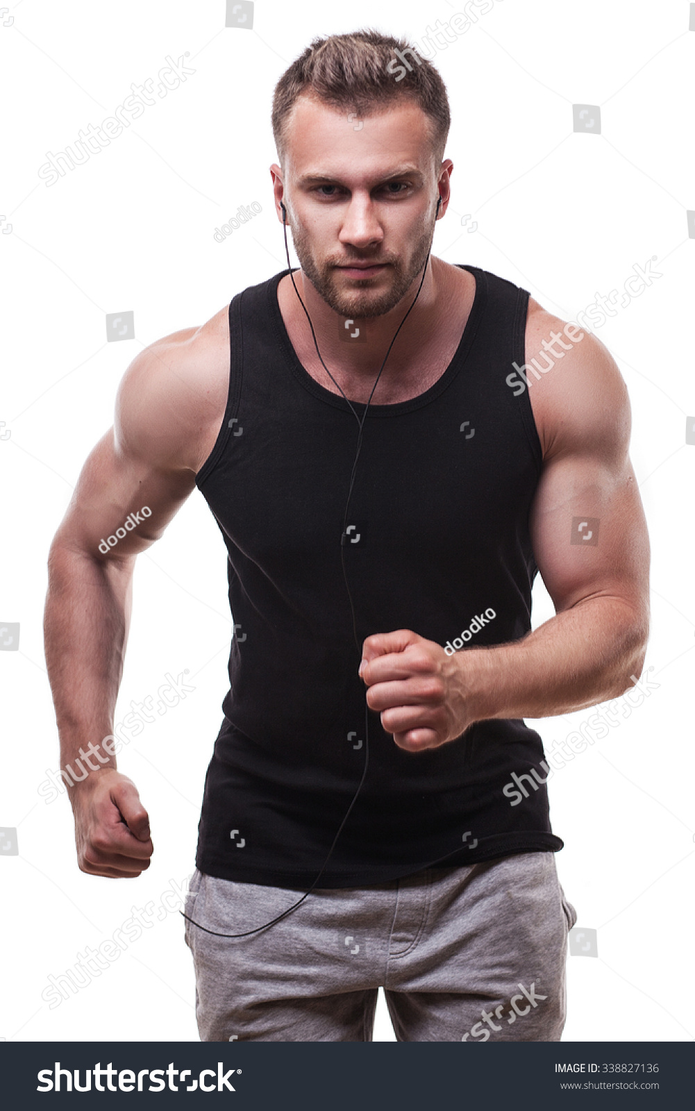 Studio Portrait Of A Male Athlete Running Isolated On White Background