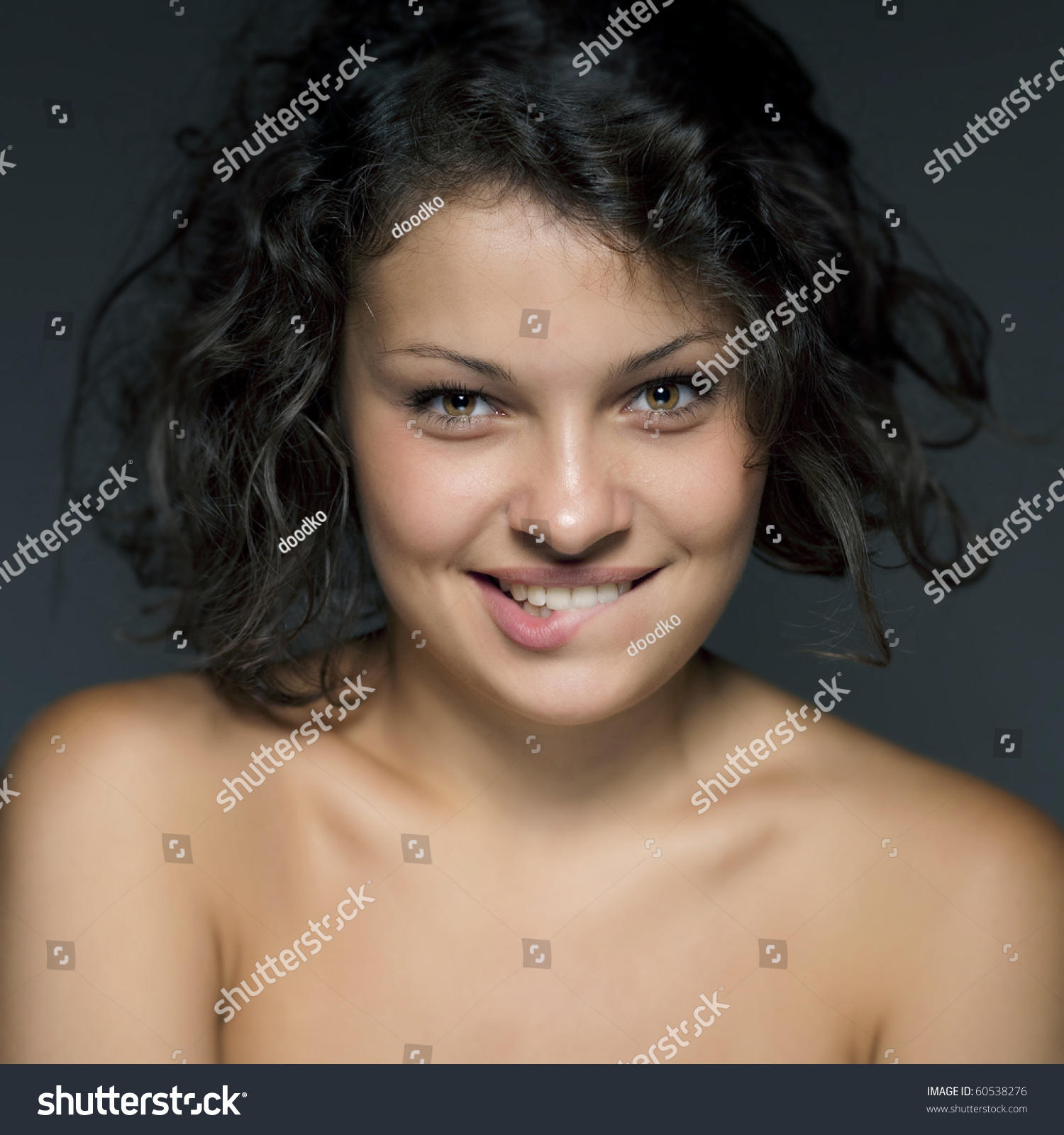 Studio Portrait Of Attractive Young Woman On Blue Background Stock