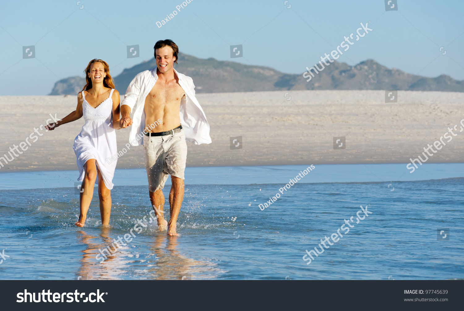 Summer Beach Love Couple Run Through The Shallow Water Splashing And