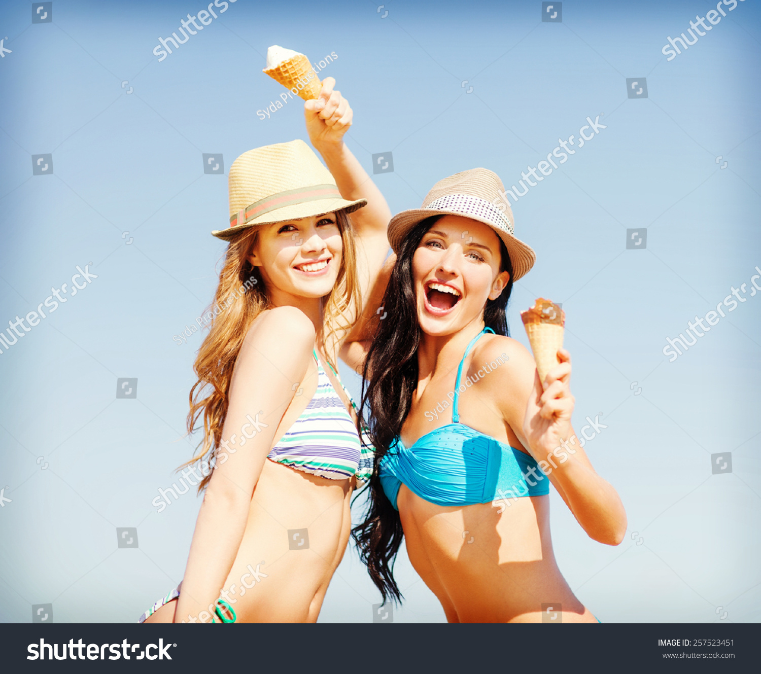summer holidays and vacation concept girls in bikini with ice cream on the beach summer holidays and vacation concept girls in bikini with ice cream on the beach
