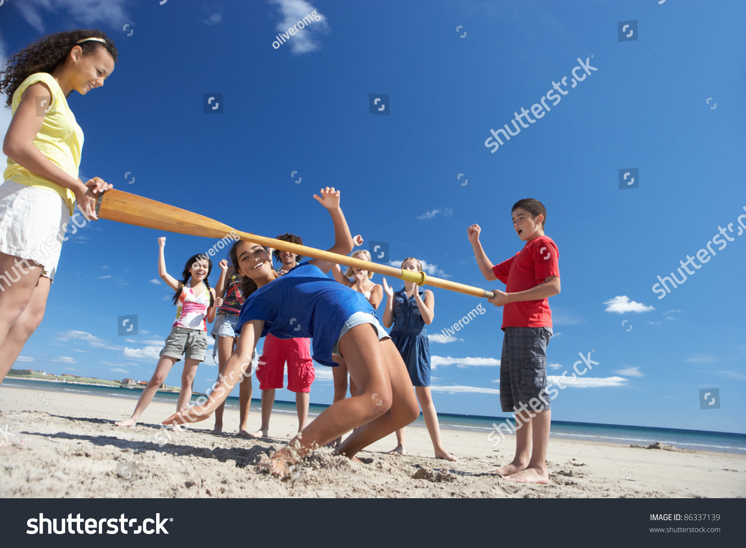 stock-photo-teenagers-doing-limbo-dance-on-beach-86337139.jpg