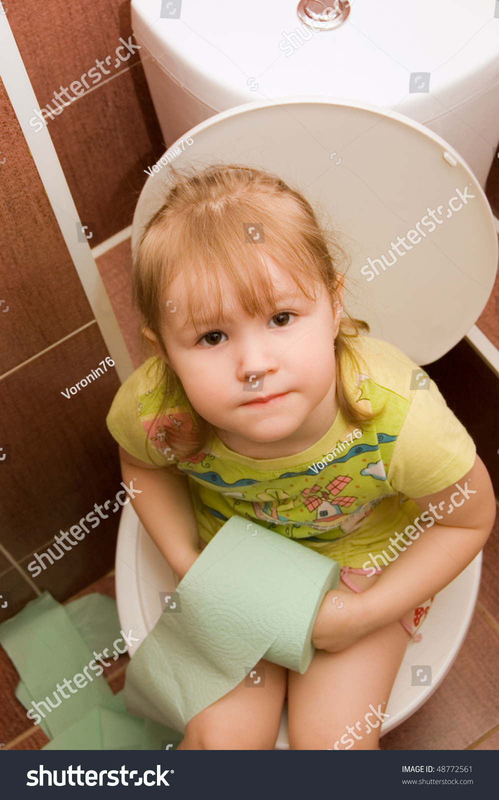 The Little Girl Sits On A Toile