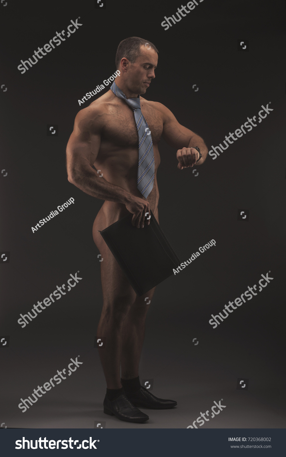 Muscular Sexy Naked Businessman Checking Time Stock Photo