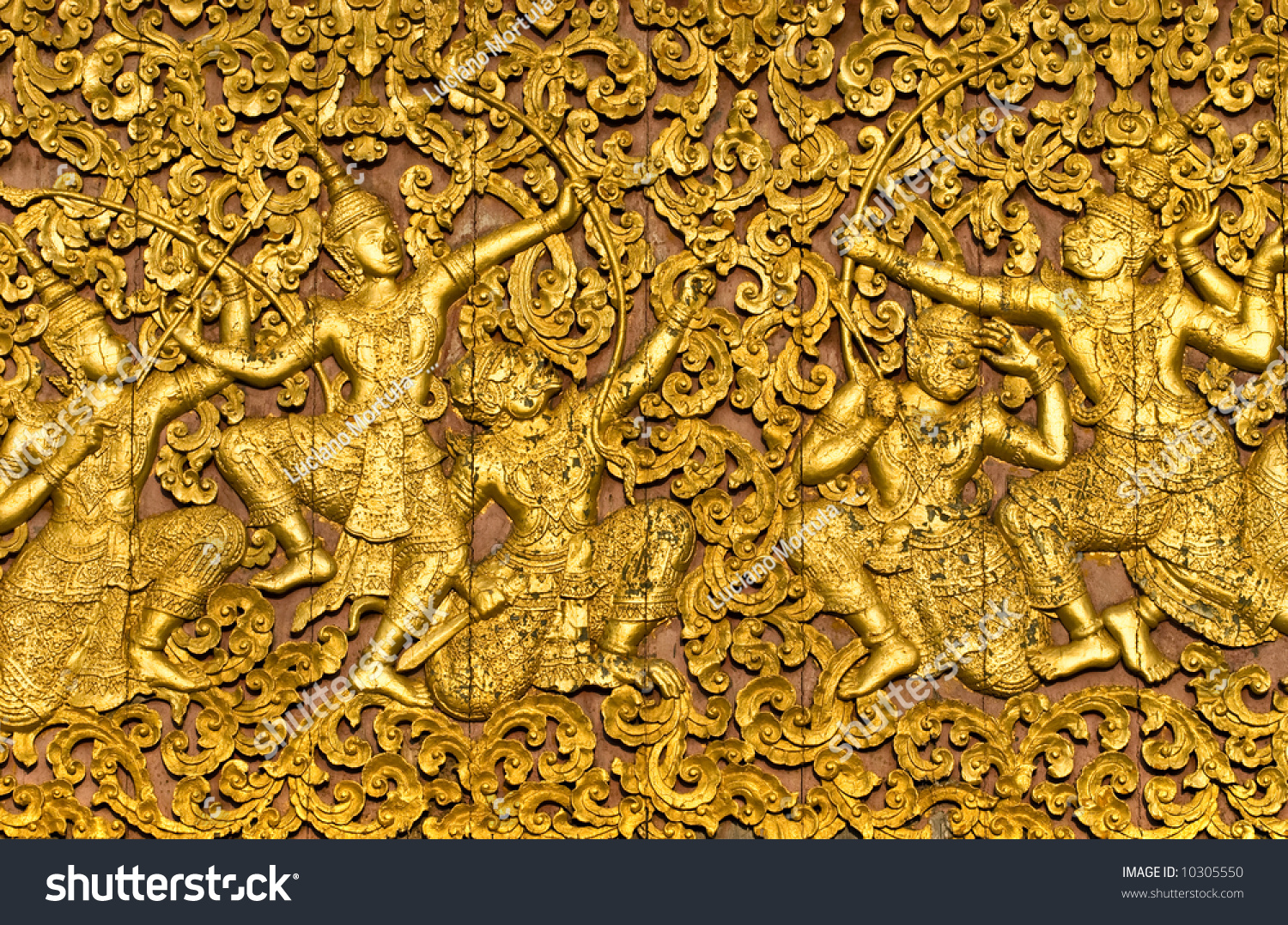 The ramayana epic carved on a wood door inside a temple Luang Prabang Laos The ramayana epic carved on a wood door inside a temple Luang Prabang Laos