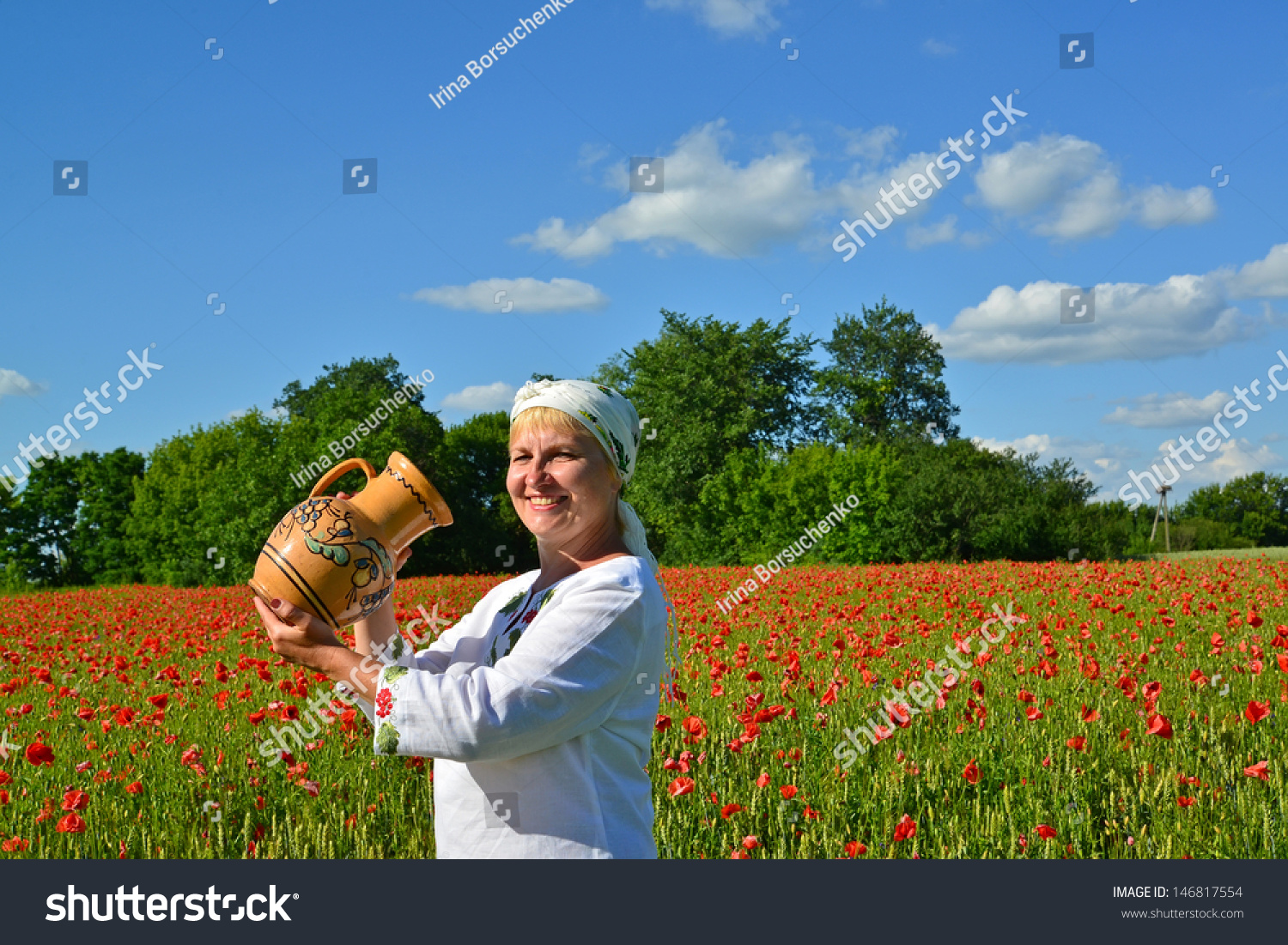 The rural woman drinks water from a jug in a poppy field The rural woman drinks water from a jug in a poppy field