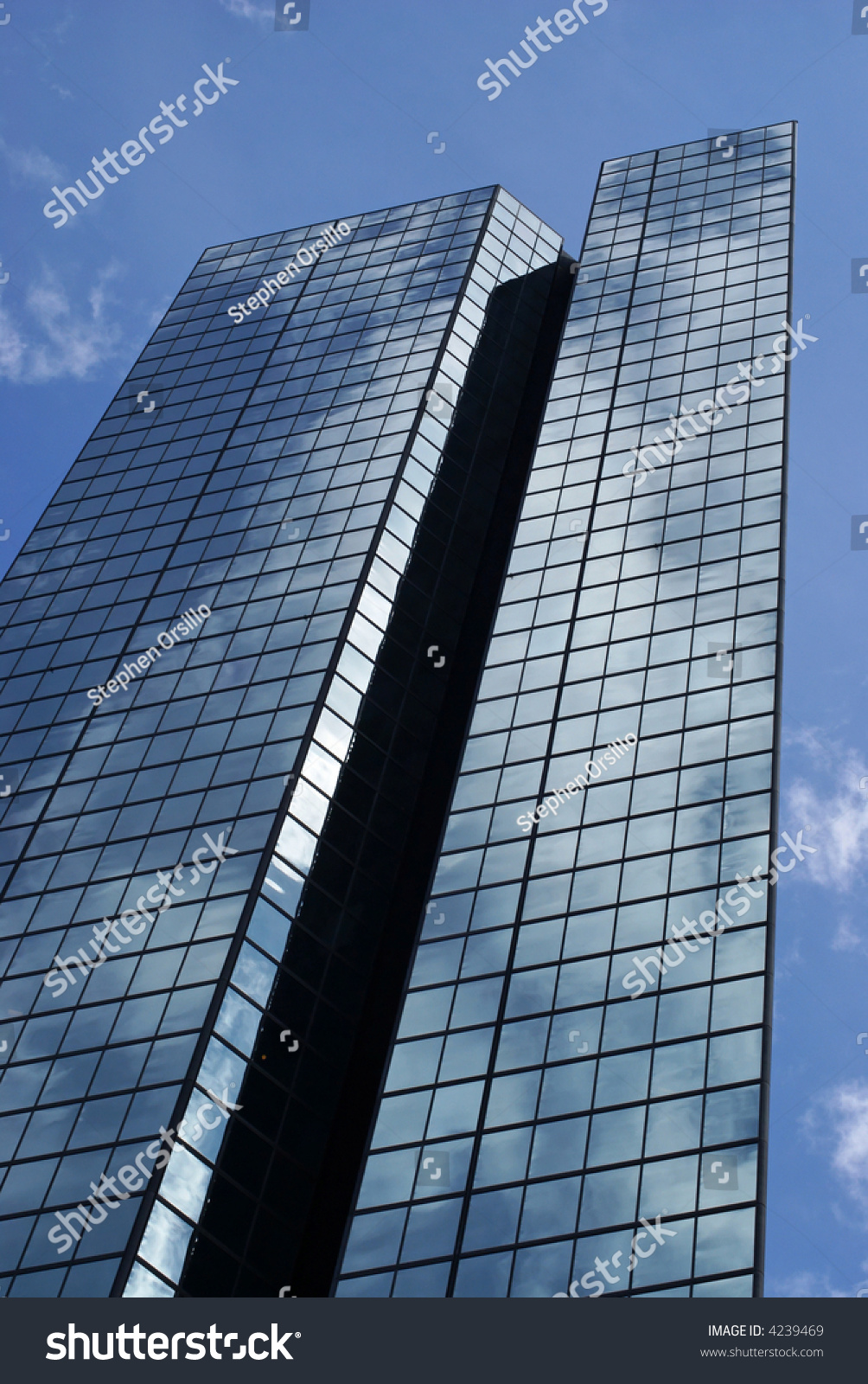 The Sky Is Vividly Reflected On Large Glass Mirrored Skyscraper 