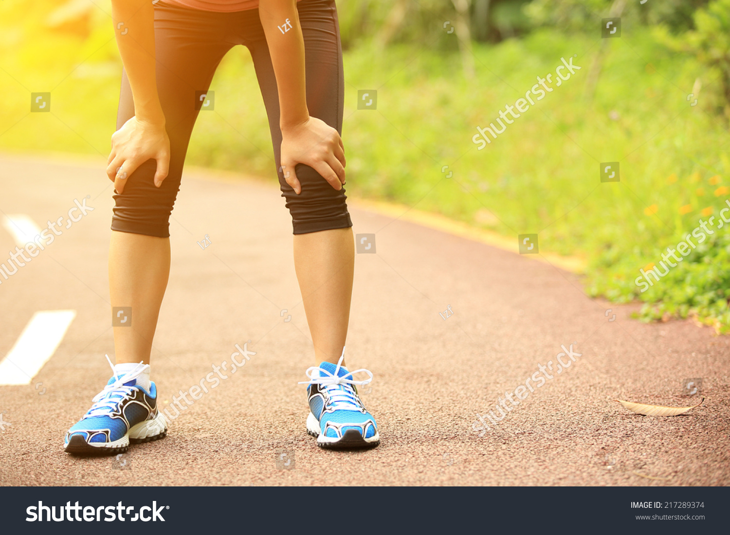Tired Woman Runner Taking A Rest After Running Hard In Countryside Road
