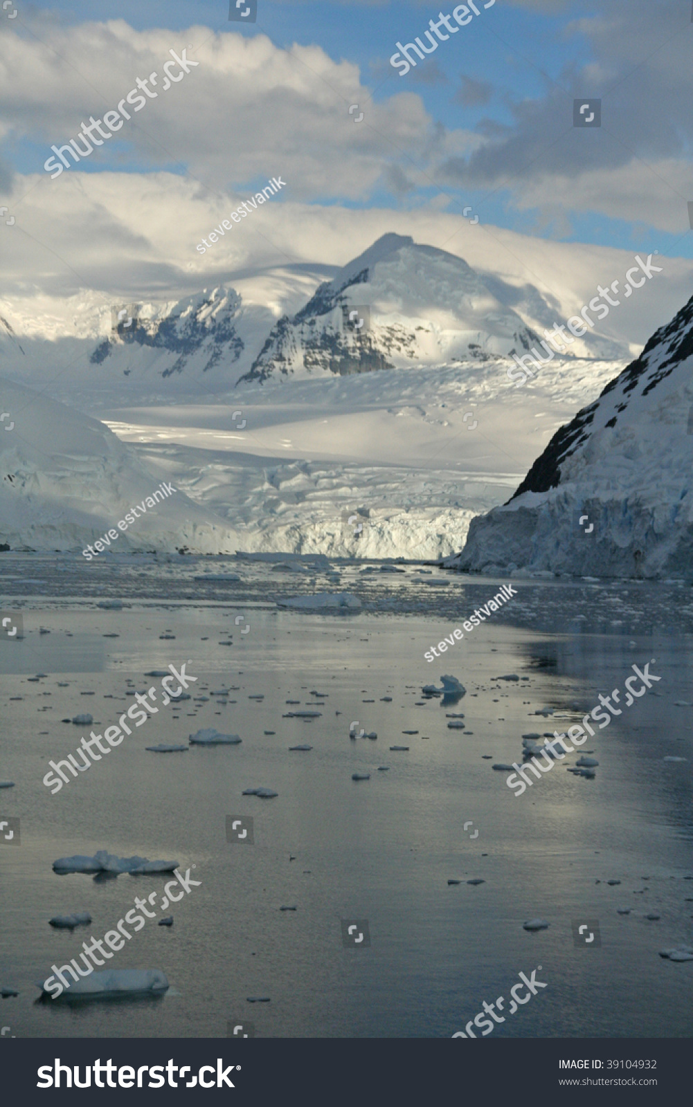 Twilight Icy Mountains Reflected On Calm Seas With Brash Ice Forming