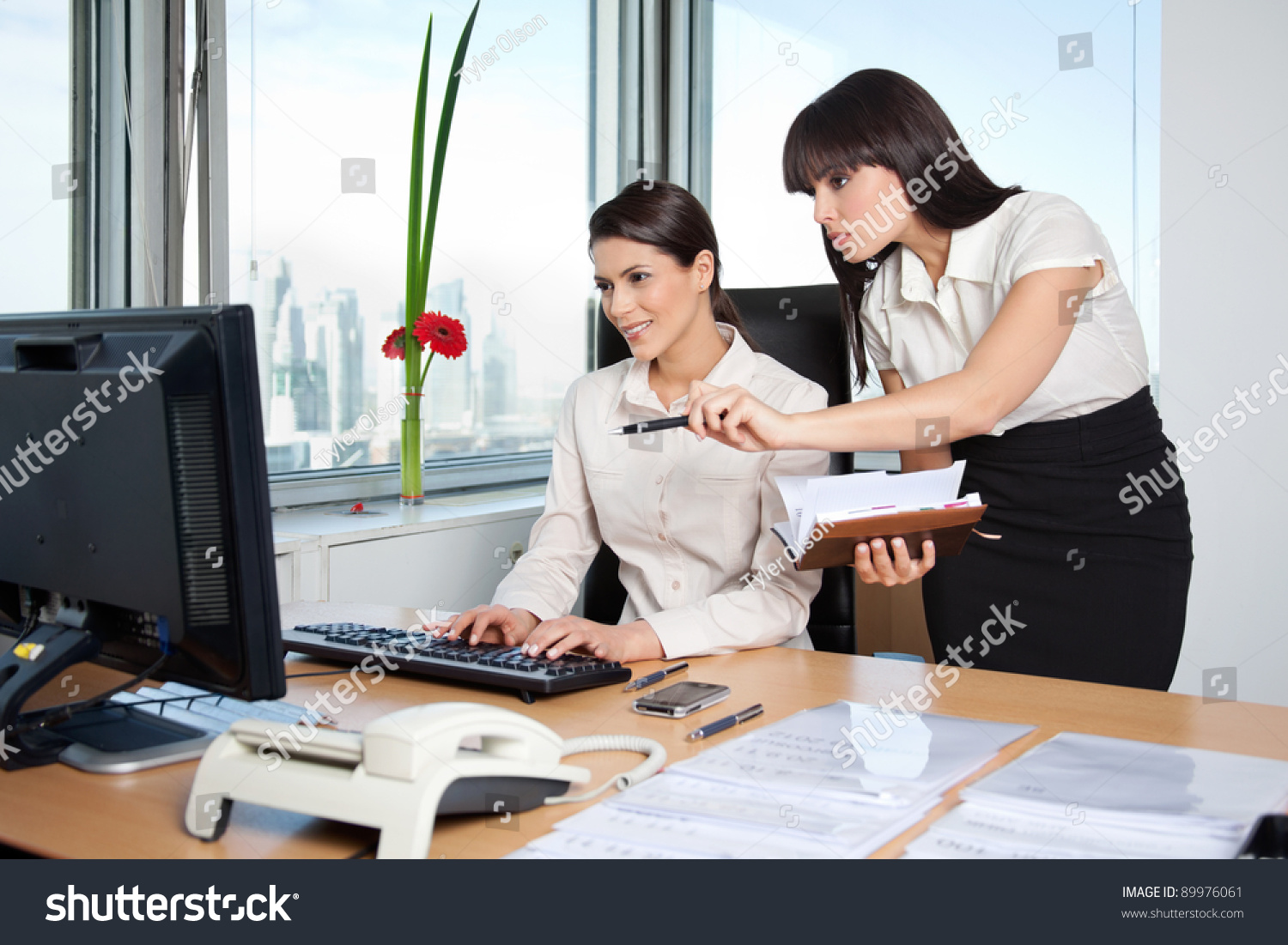 http://image.shutterstock.com/z/stock-photo-two-female-business-women-in-office-setting-working-89976061.jpg