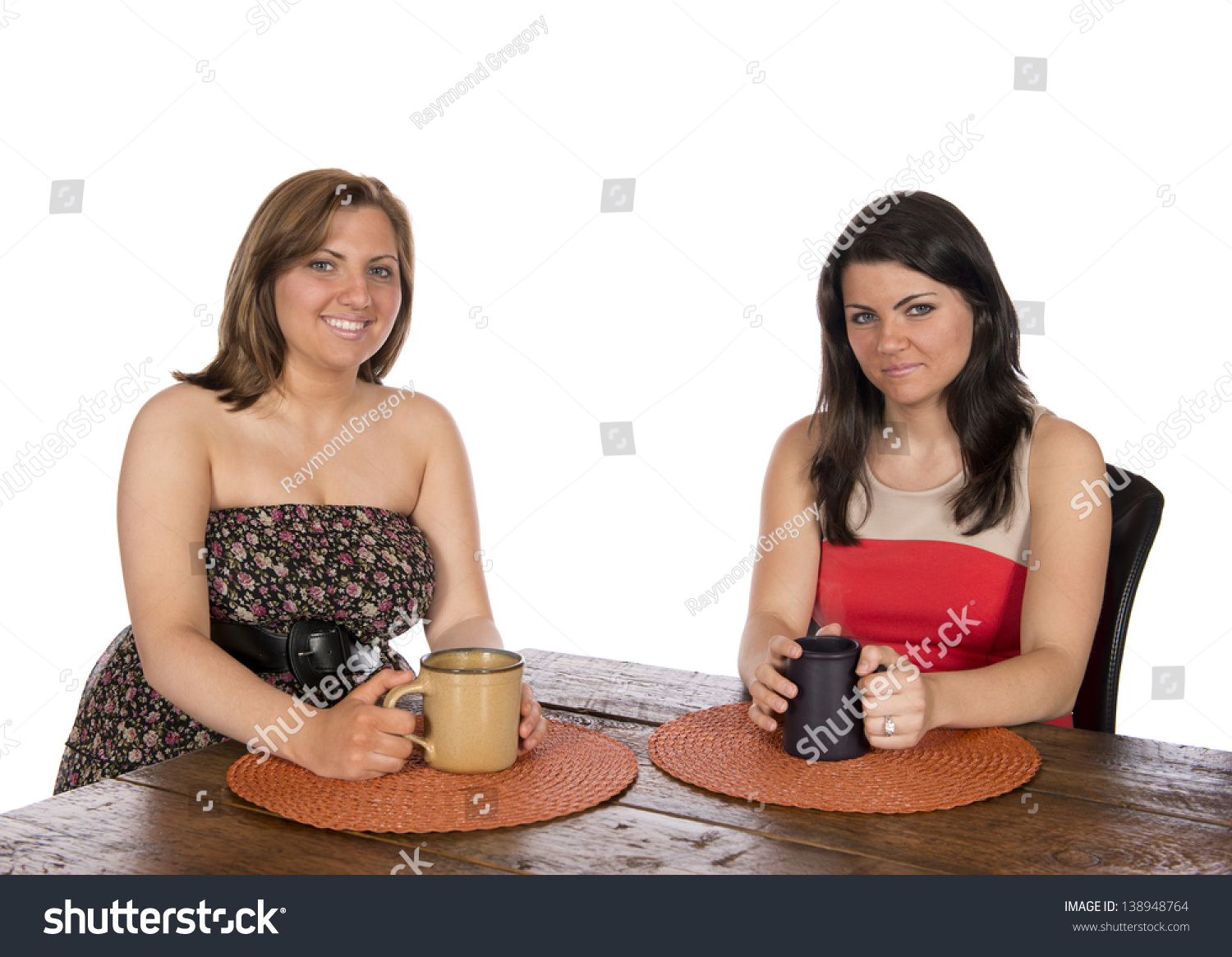 Two Happy Women Sitting At A Table Each With A Cup Of Coffee Or Coco Casual Formal Dressed In 
